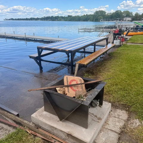 Customer fire pit at the edge of a lake