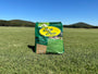 Bag of Zerith Zoysia seed on a grassy field with a clear blue sky