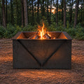 Campfire burning at dusk in a wooded yard