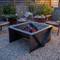 Edge Right fire pit at dusk on a gravel patio with chairs